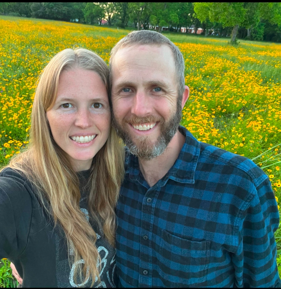 Nick and Christine in a field of yellow flowers